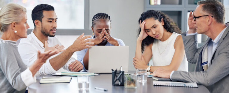 Shot of a group of businesspeople looking stressed out while working together in an office